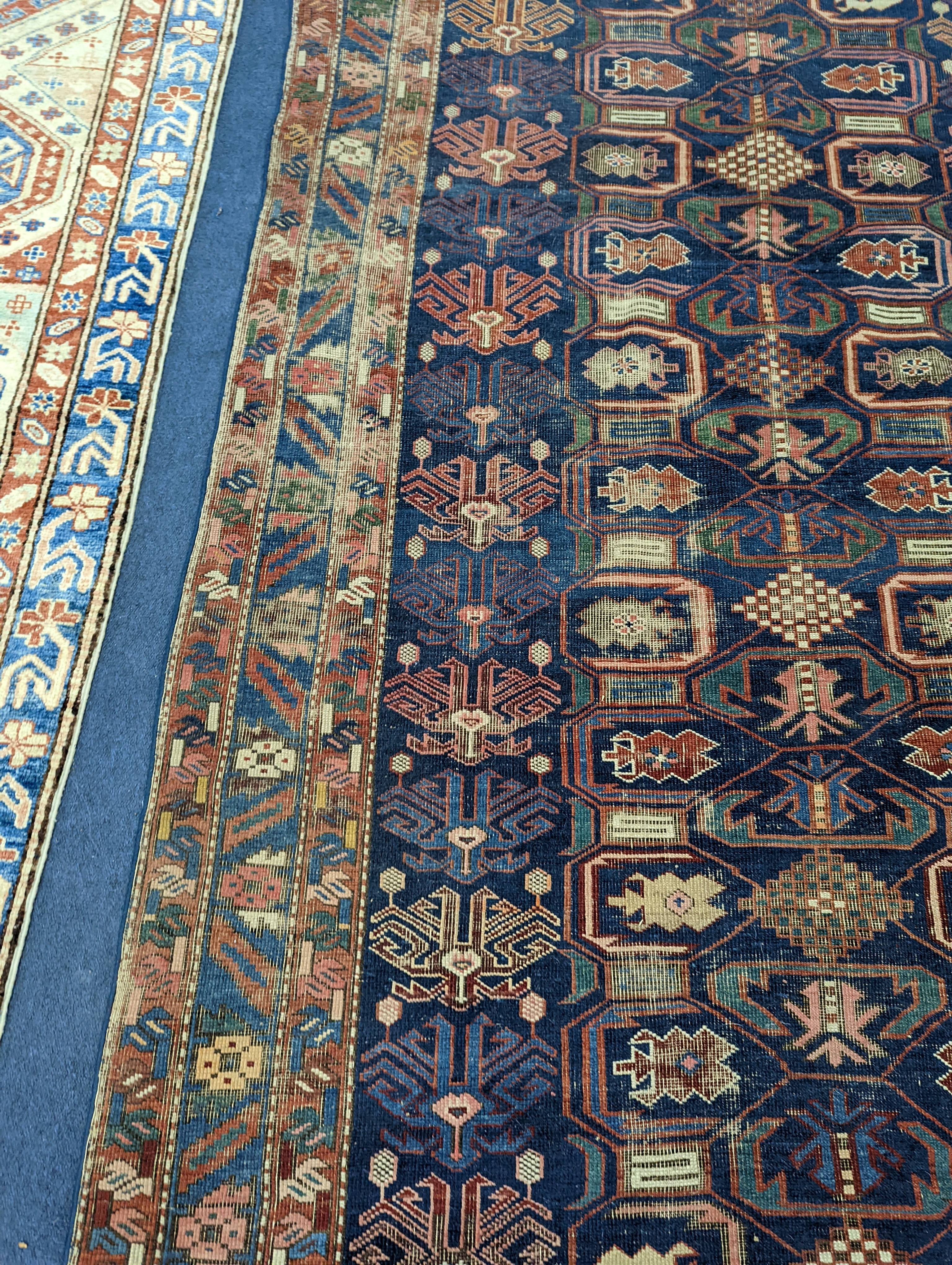 An antique Caucasian blue ground rug, 260 x 130cm